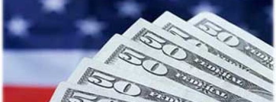 American flag with a fan of fifty dollar bills in the foreground